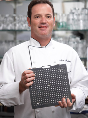 Chef holding Golden Fry Tech Plate